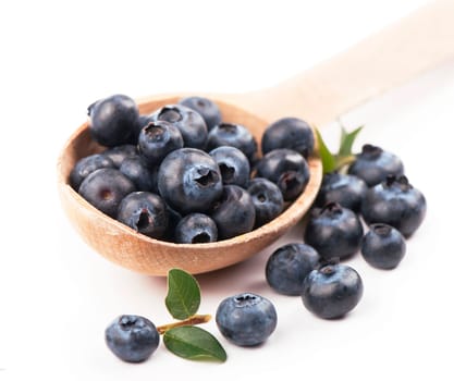 Blueberries in wooden spoon isolated on white background, full depth of field