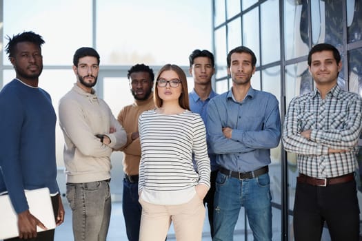 Confident in your team. Attractive young business people smiling while standing in a row with other people