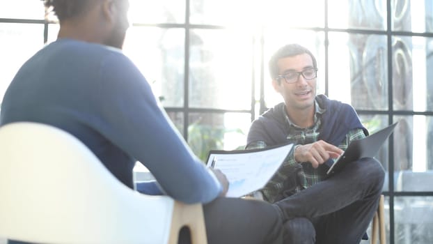 Positive young people fills in information in the questionnaire, applying for a job
