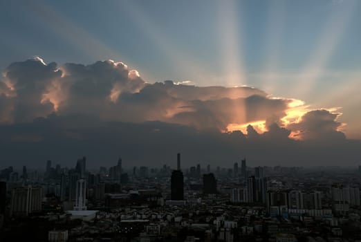 Divine glow through the Clouds of the Morning or Evening warm Sun over Large Metropolitan city with Skyscrapers on Background. The Stunning Beauty of a Sunrise or Sunset, They can be used as Wallpaper that look Amazing, Space for text, Selective focus.