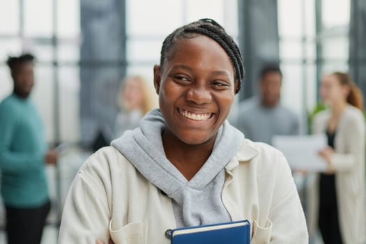 Attractive young office worker holding large file