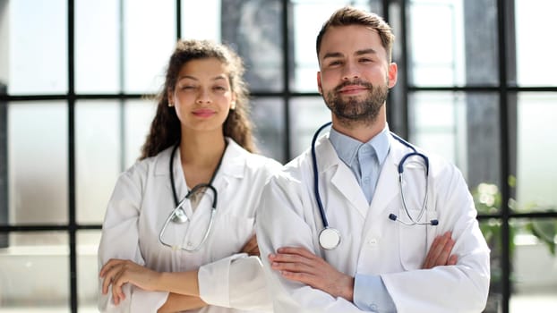 female doctor and male doctor stand in the lobby of the hospital