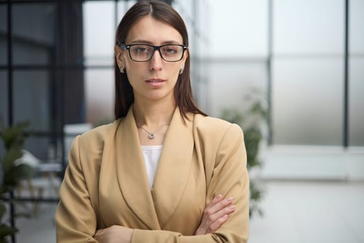Attractive woman looking pensively at the camera in office