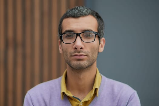Handsome businessman standing with and looking at camera