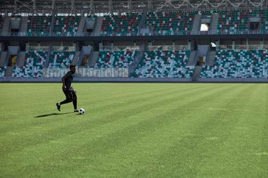 Professional football player in action at the stadium. The concept of sport, competition, movement, overcoming. The effect of the presence of the field.