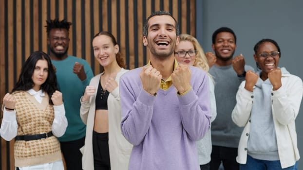 Happy people raise their hands up clenching their fists. Success concept