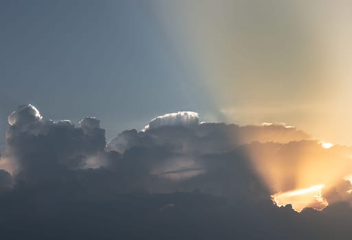 Light shines through Clouds before Sunset. Light of the Evening Sunlight, It's a Mesmerizing Scene, They can be used as Wallpaper that Look Amazing, Space for text, Selective focus.