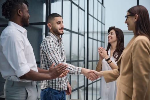 Group of successful young people standing in a conference room in the office