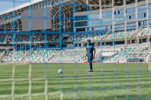 Football goal post with net, back view. Association football goal on the field