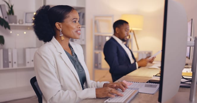 Business people working night, black woman writing report and team, computer and employee at desk with coworking. Overtime, technology and wifi, collaboration and communication with project deadline.