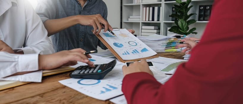 Business People Meeting using laptop computer,calculator,notebook,stock market chart paper for analysis Plans to improve quality next month. Conference Discussion Corporate Concept