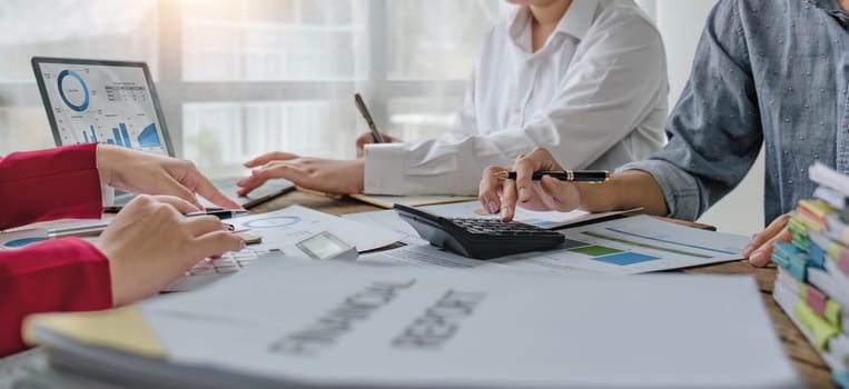 Business People Meeting using laptop computer,calculator,notebook,stock market chart paper for analysis Plans to improve quality next month. Conference Discussion Corporate Concept