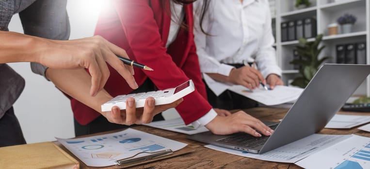 Business People Meeting using laptop computer,calculator,notebook,stock market chart paper for analysis Plans to improve quality next month. Conference Discussion Corporate Concept