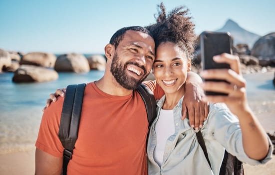 Couple, phone selfie and beach travel adventure together for social media, holiday vacation and summer in nature. Man, happy woman and hug for mobile phone photograph at ocean sea for happiness.