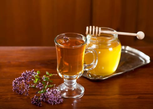 Still life from medicinal herbs, honey, herbal tea on a wooden background