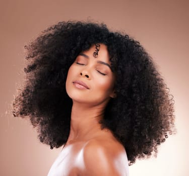 Natural hair, black woman with face and haircare, beauty with skincare and cosmetics on studio background. Female, cosmetic treatment and content with curly hairstyle, texture and afro with skin glow.