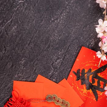 Design concept of Chinese lunar January new year - Festive accessories, red envelopes (ang pow, hong bao), top view, flat lay, overhead above. The word 'chun' means coming spring.