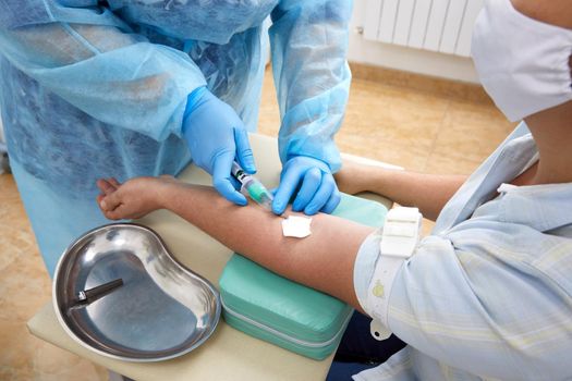 Nurse doing blood test from vein. Covid testing concept
