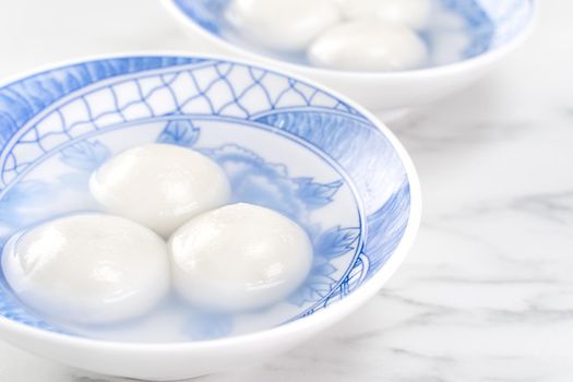 Delicious tang yuan, yuanxiao in a small bowl. Asian traditional festive food rice dumplings ball with stuffed fillings for Chinese Lantern Festival, close up.