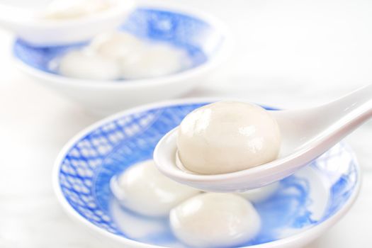 Delicious tang yuan, yuanxiao in a small bowl. Asian traditional festive food rice dumplings ball with stuffed fillings for Chinese Lantern Festival, close up.