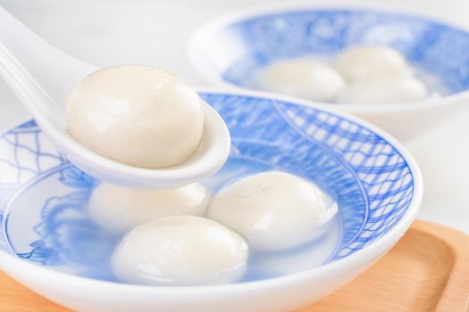 Delicious tang yuan, yuanxiao in a small bowl. Asian traditional festive food rice dumplings ball with stuffed fillings for Chinese Lantern Festival, close up.