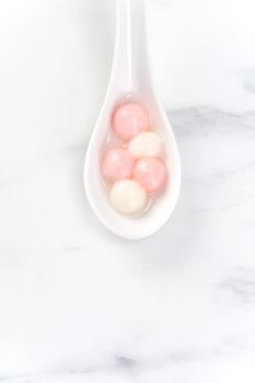 Tang yuan, tangyuan, delicious red and white rice dumpling balls in a small bowl, top view, flat lay. Asian festive food for Winter Solstice Festival.