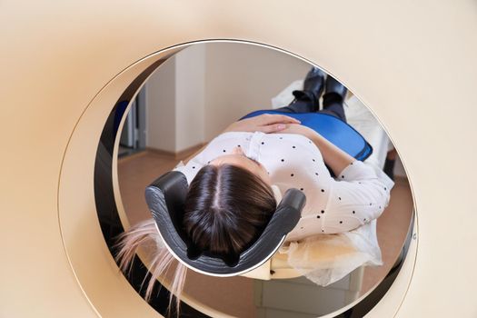 Female patient undergoing MRI - Magnetic resonance imaging in a Hospital. Medical Equipment and Health Care