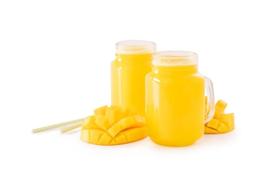 Fresh tropical mango juice with beautiful diced fruit flesh, striped paper straw isolated on white background table, close up, cut out, clipping path.