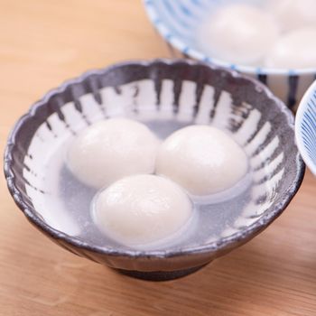 Tang yuan, tangyuan, yuanxiao in a small bowl. Delicious asian traditional festive food rice dumpling balls with stuffed fillings for Chinese Lantern Festival, close up.