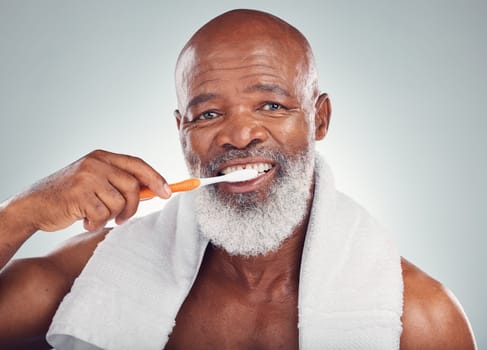 Black man, dental hygiene and toothbrush with wellness, brushing teeth and smile on grey studio background. Oral health, African American male and guy clean mouth, fresh breath and grooming routine.