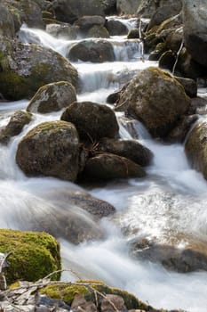 Long exposure picture showing rocks and sikly water in Vall de Boi in Catalonia