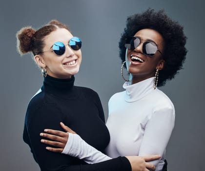 Fashion, futuristic and women smile in sunglasses, cyberpunk and trendy designer brand with gen z youth. Marketing, diversity and contemporary style with vision and edgy against studio background.