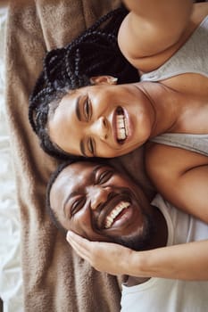 Selfie, love and black couple portrait in bedroom happy and funny while laughing on bed at home or hotel. Top view smile of a man and woman in marriage with commitment and happiness for social media.