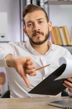 Business man reading business contract, planning project, analyzing resume, shakes finger, saying No, unsatisfied, disagree, candidate with failure at office talking, online interview. Vertical shot