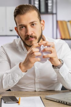Angry boss business man making webcam online video call talking colleague conversation analyzing financial report mistake problem, crumples paper throws it away at office. Conflict, quarrel. Vertical