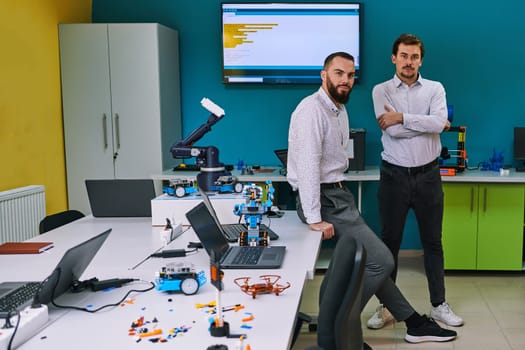 A group of colleagues collaborate in a lab while testing a 3D printer, demonstrating their commitment to technological advancement and scientific research