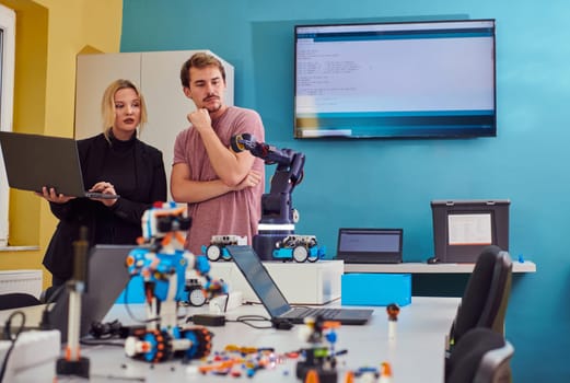 A group of colleagues working together in a robotics laboratory, focusing on the intricate fields of robotics and 3D printing. Showcase their dedication to innovation, as they engage in research, development, engineering, and precision work.