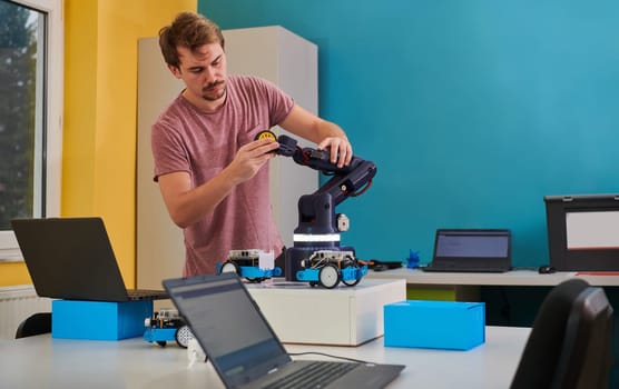 A student testing his new invention of a robotic arm in the laboratory, showcasing the culmination of his research and technological prowess