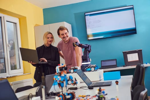 A group of colleagues working together in a robotics laboratory, focusing on the intricate fields of robotics and 3D printing. Showcase their dedication to innovation, as they engage in research, development, engineering, and precision work.