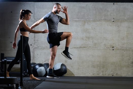 A fit couple in a modern gym, engaging in running exercises and showcasing their athletic prowess with a dynamic start