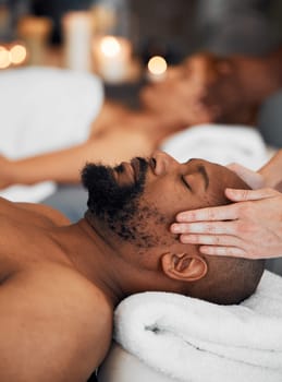 Spa, black man and woman, massage, relax and romantic for peaceful, focus and calm. African American couple, wellness and enjoy retreat for health with luxury holiday, stress relief or lay on table.