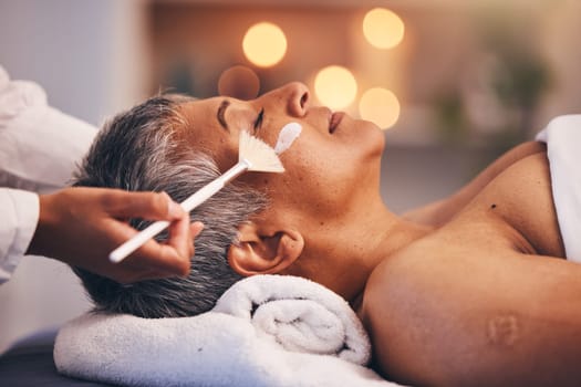 Spa, facial and senior black woman with mask for skincare, beauty and luxury treatment at beauty salon. Wellness, face massage and mature female relax on holiday, vacation and retirement at resort.
