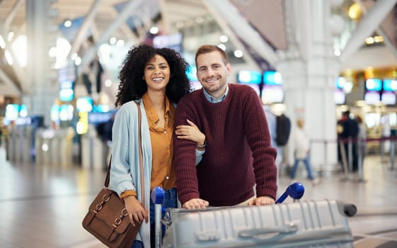 Travel, happy and portrait of interracial couple in airport for vacation, journey and transportation. Love, smile and luggage with man and black woman on holiday trip for tourism, flight or departure.