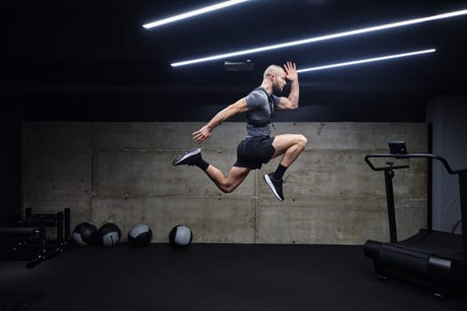 A muscular man captured in air as he jumps in a modern gym, showcasing his athleticism, power, and determination through a highintensity fitness routine.