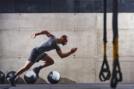 A muscular man captured in air as he jumps in a modern gym, showcasing his athleticism, power, and determination through a highintensity fitness routine.