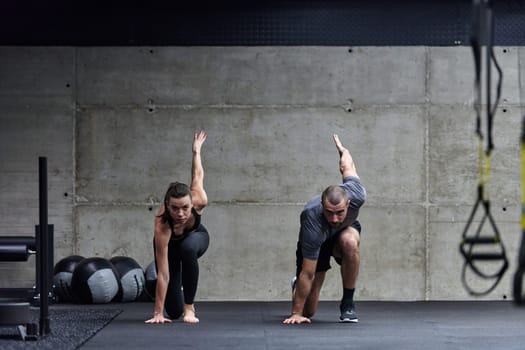 A fit couple in a modern gym, engaging in running exercises and showcasing their athletic prowess with a dynamic start