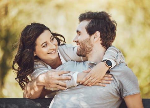 Hug, love and couple on park bench, smile and having fun time together outdoors. Valentines day, romance relax and care of happy man and woman hugging, embrace and cuddle on romantic date outside
