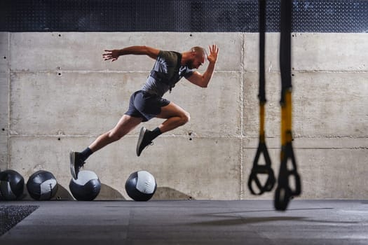 A muscular man captured in air as he jumps in a modern gym, showcasing his athleticism, power, and determination through a highintensity fitness routine.