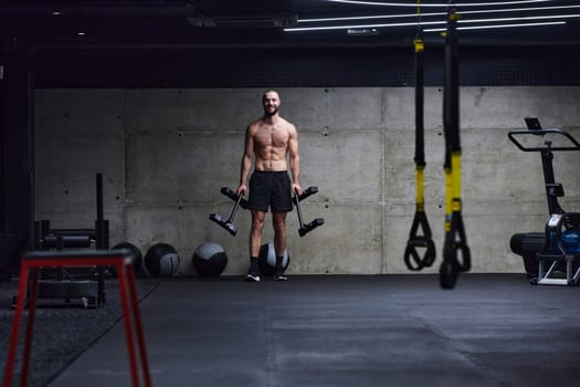 A muscular man performs shoulder exercises in a modern gym, showcasing his strength and dedication to fitness