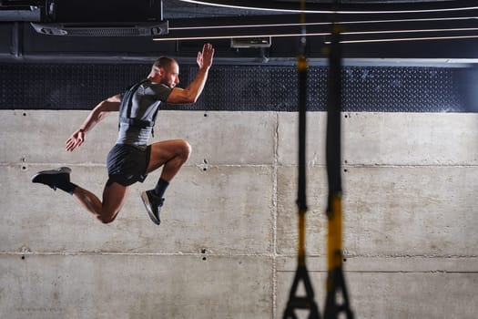 A muscular man captured in air as he jumps in a modern gym, showcasing his athleticism, power, and determination through a highintensity fitness routine.